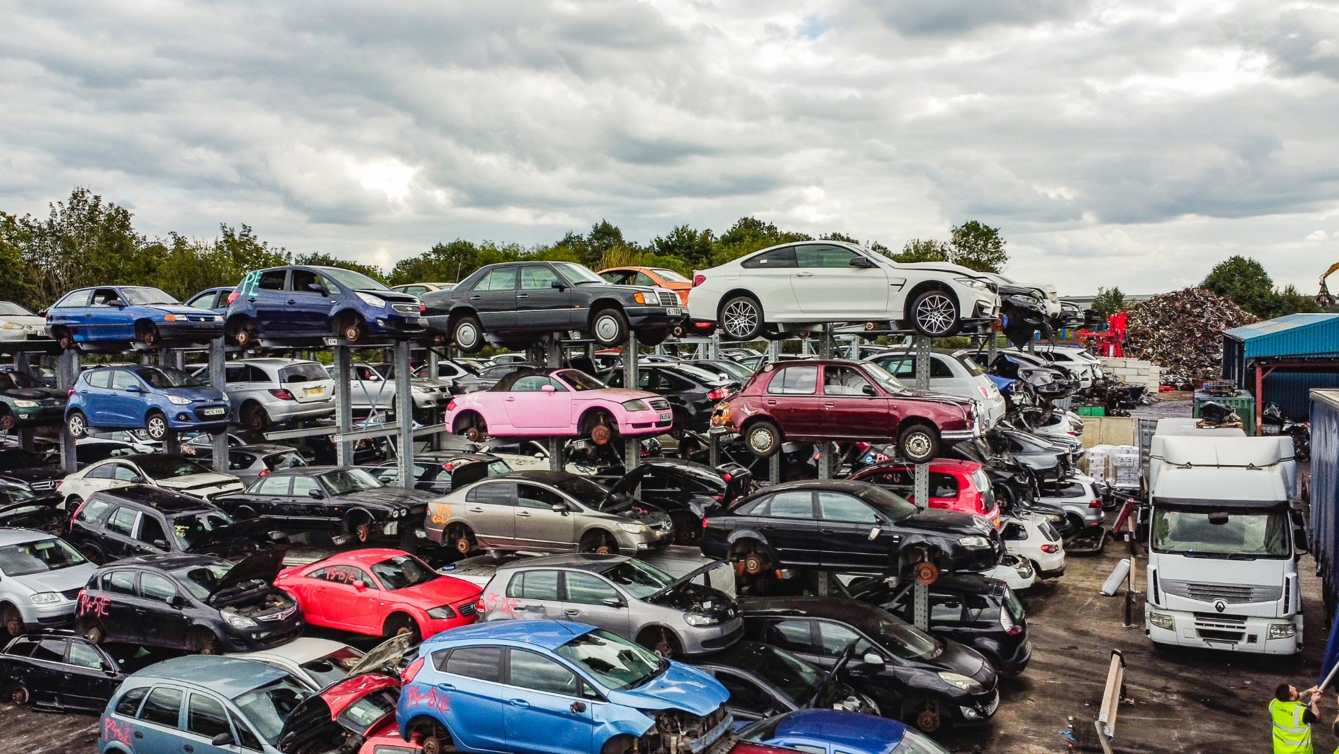 Stacked scrap cars at golden hour